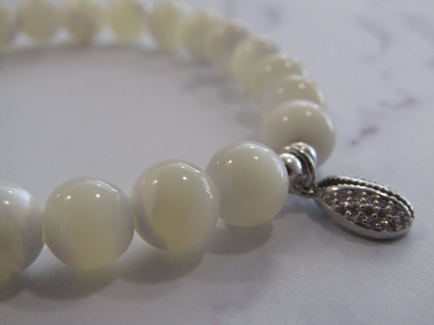 Natural white shell bracelet with 925 sterling silver spacer beads and Cubic Zirconia charm (8mm)