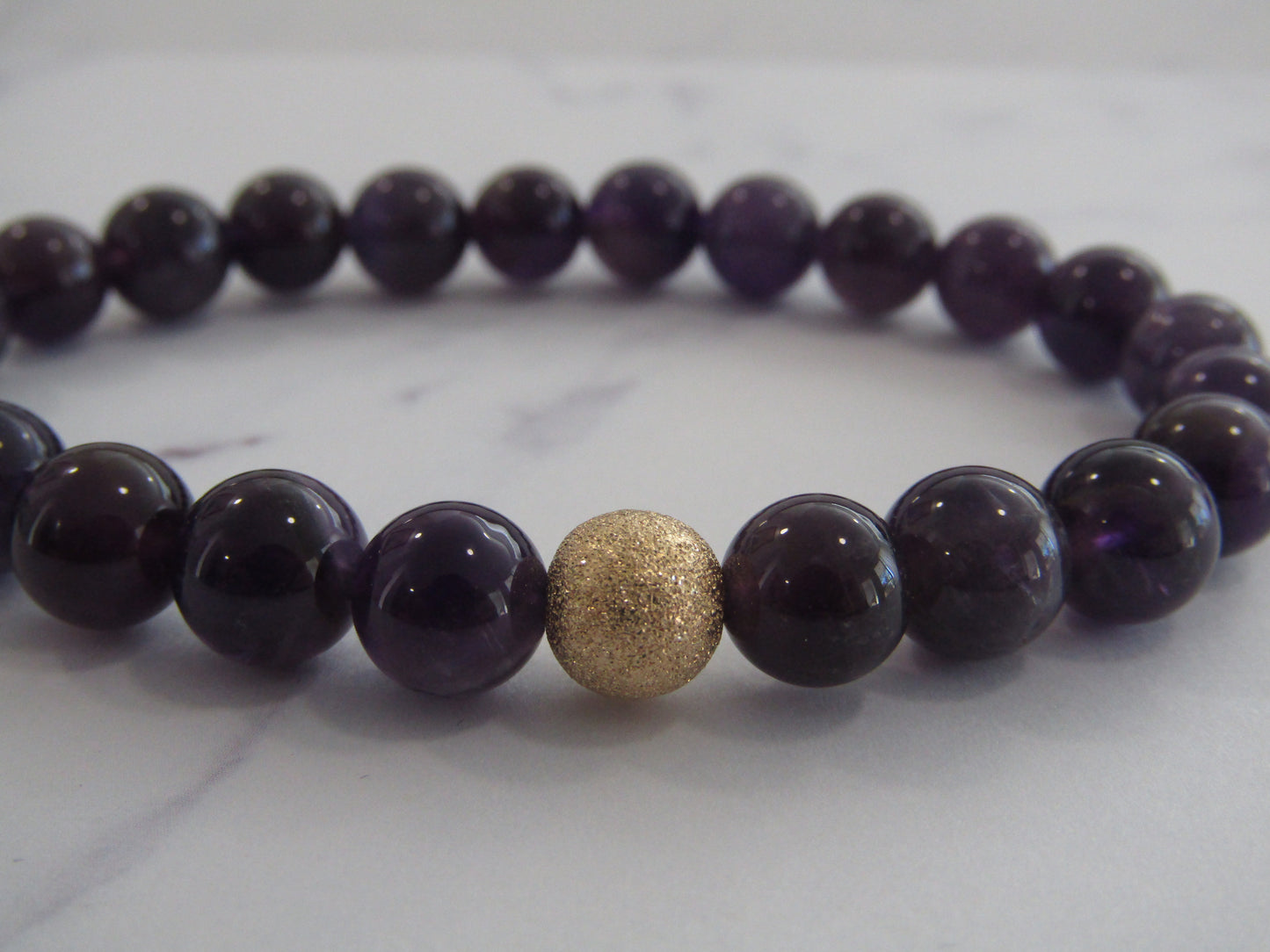 Grade A+ Amethyst bracelet with 14k gold filled starburst bead (8mm)