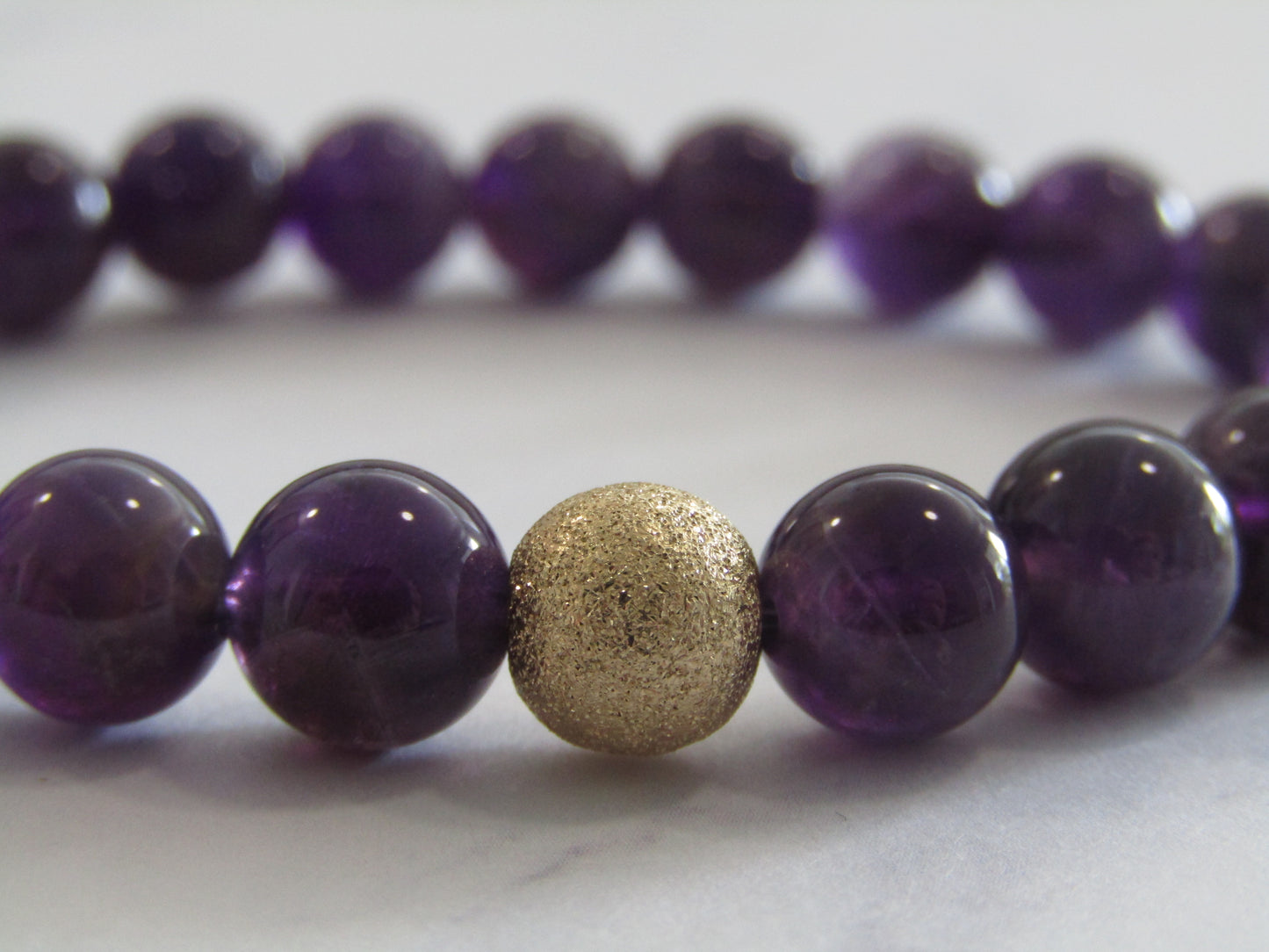 Grade A+ Amethyst bracelet with 14k gold filled starburst bead (8mm)