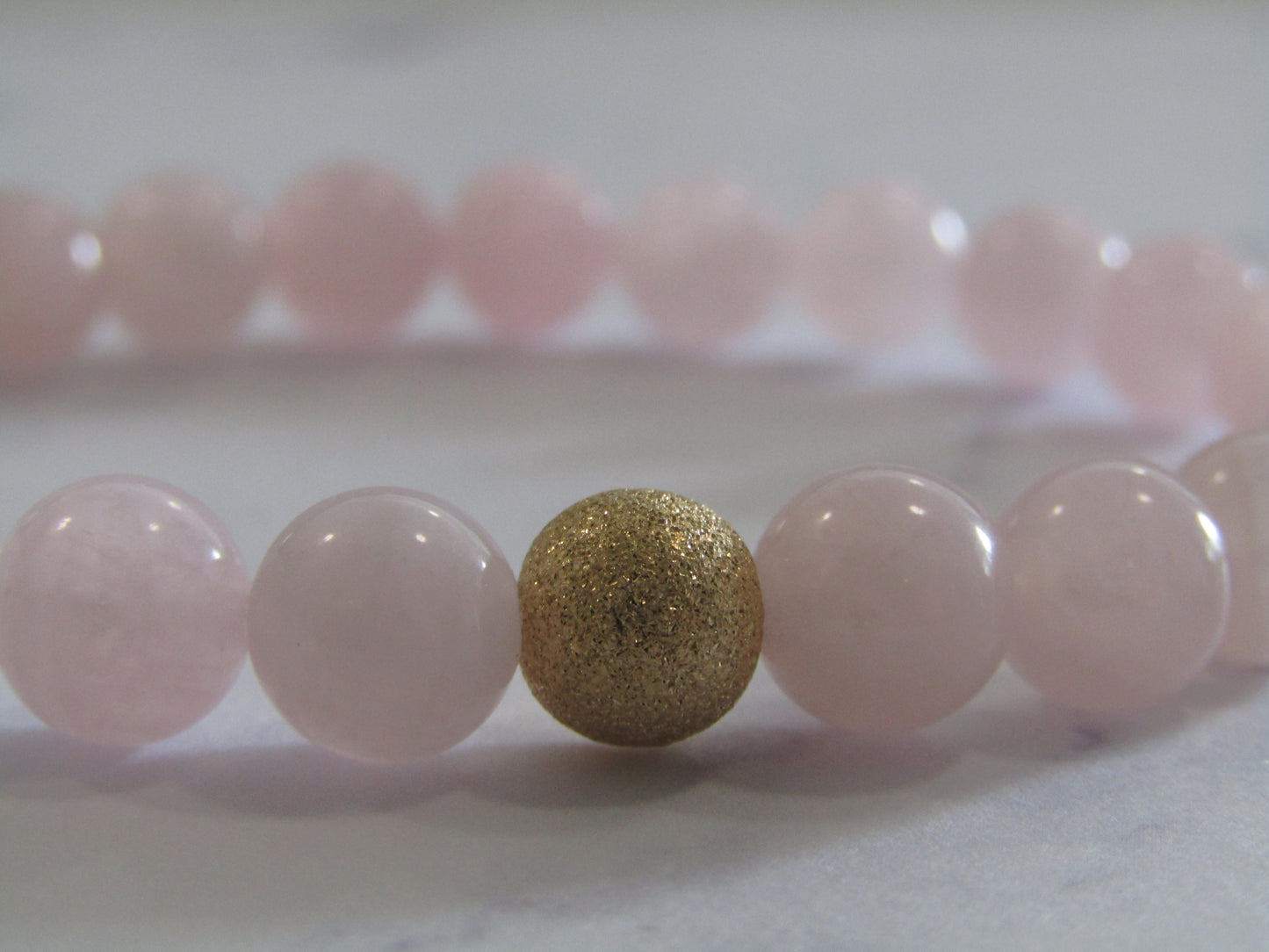 Grade A Madagascar Rose Quartz bracelet with 14k gold filled starburst bead