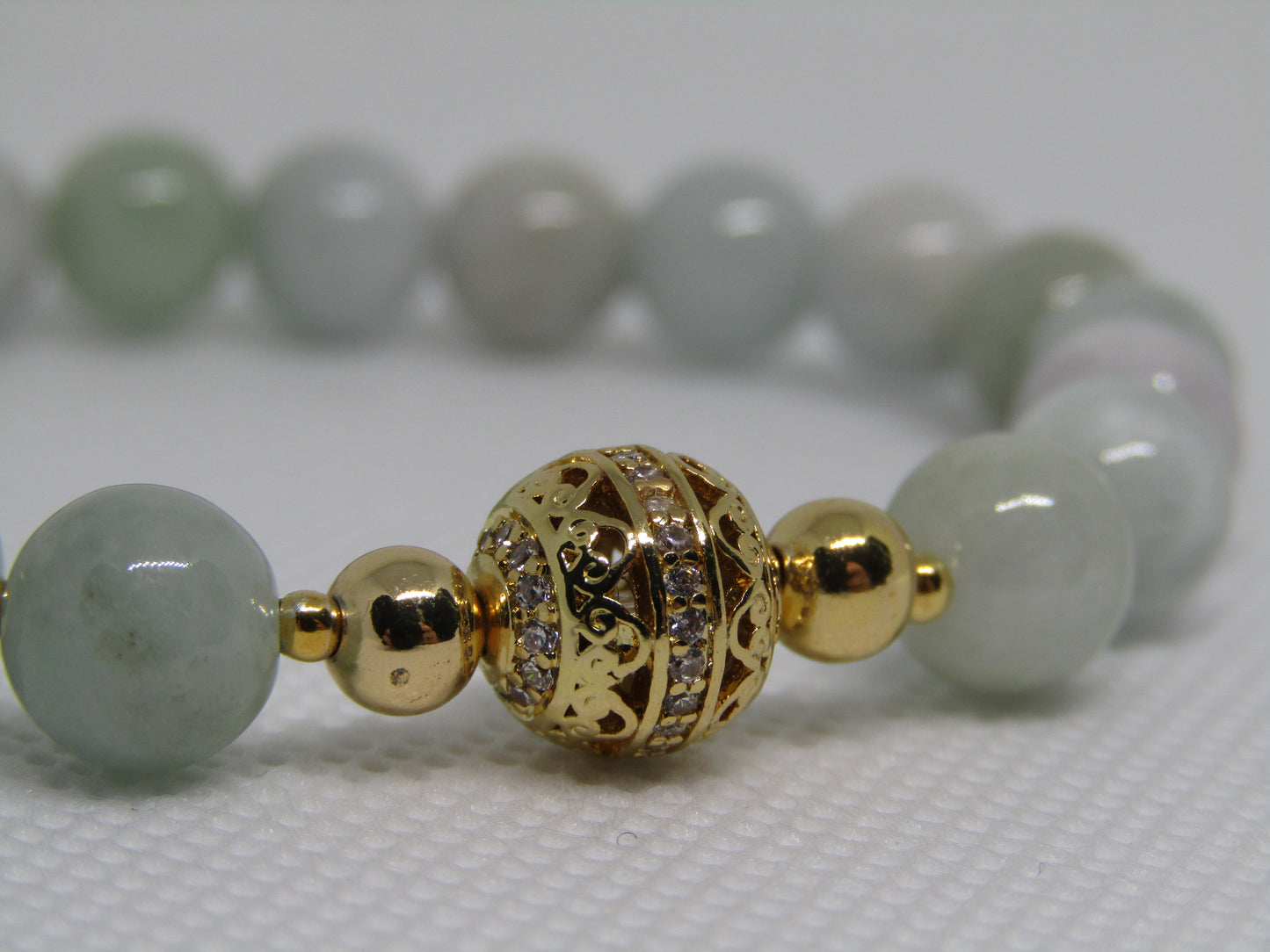 Grade A Jadeite (8mm) bracelet with 18k gold plated Cubic Zirconia bead and 18k gold plated spacers