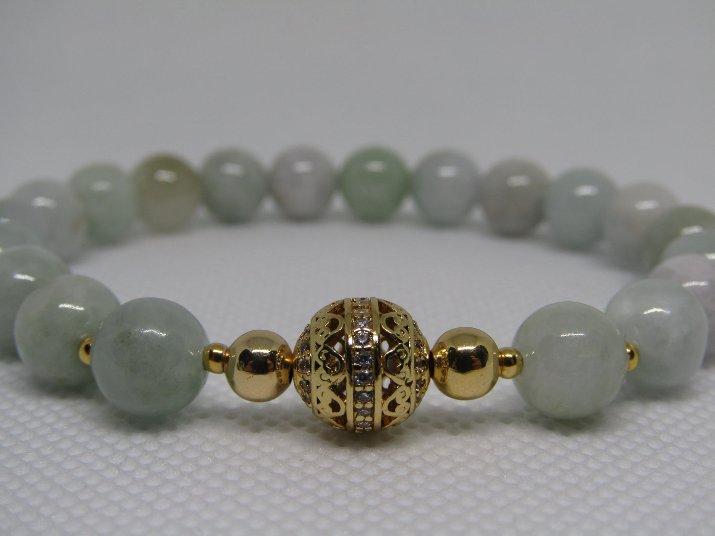 Grade A Jadeite (8mm) bracelet with 18k gold plated Cubic Zirconia bead and 18k gold plated spacers