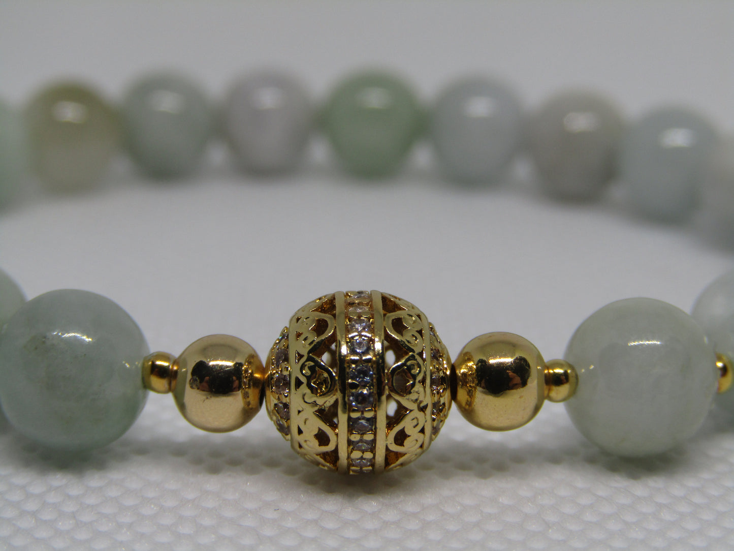 Grade A Jadeite (8mm) bracelet with 18k gold plated Cubic Zirconia bead and 18k gold plated spacers