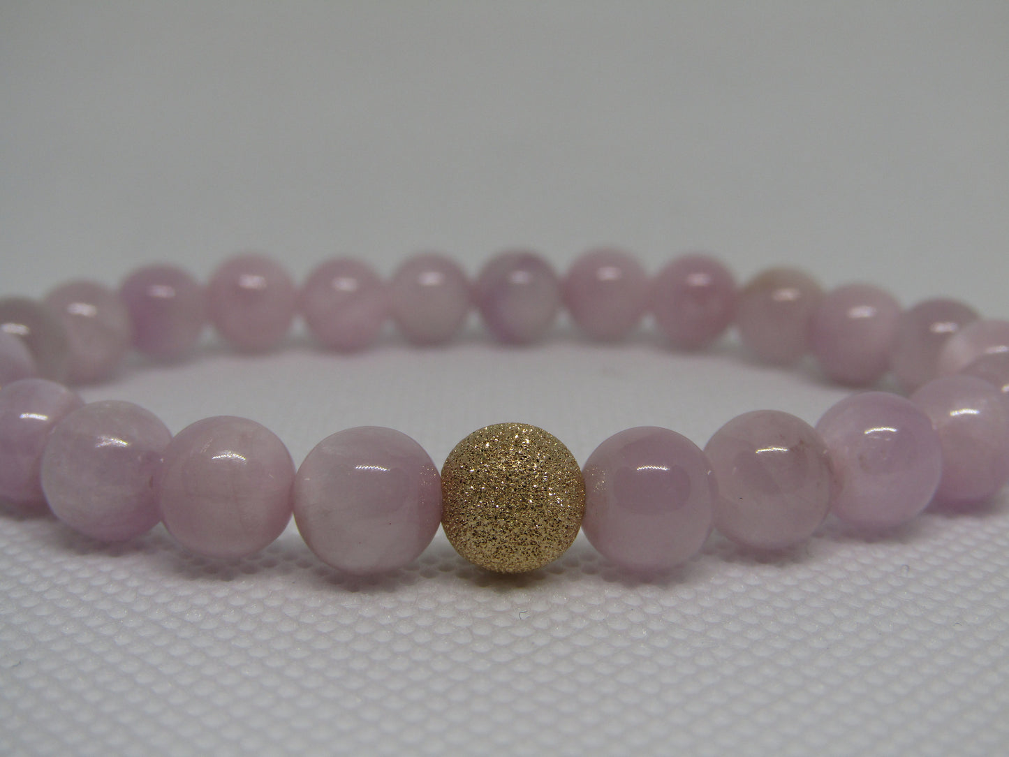 Grade A Kunzite (8mm) bracelet with 14k gold filled starburst bead