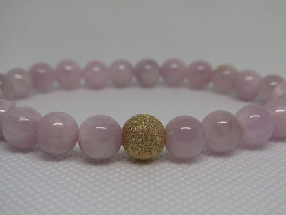 Grade A Kunzite (8mm) bracelet with 14k gold filled starburst bead