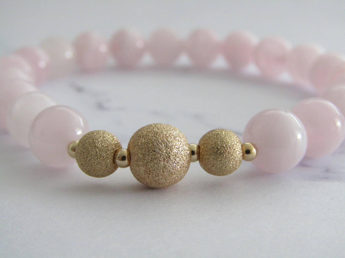 Grade A Madagascar Rose Quartz  bracelet with gold filled starburst beads - 8mm