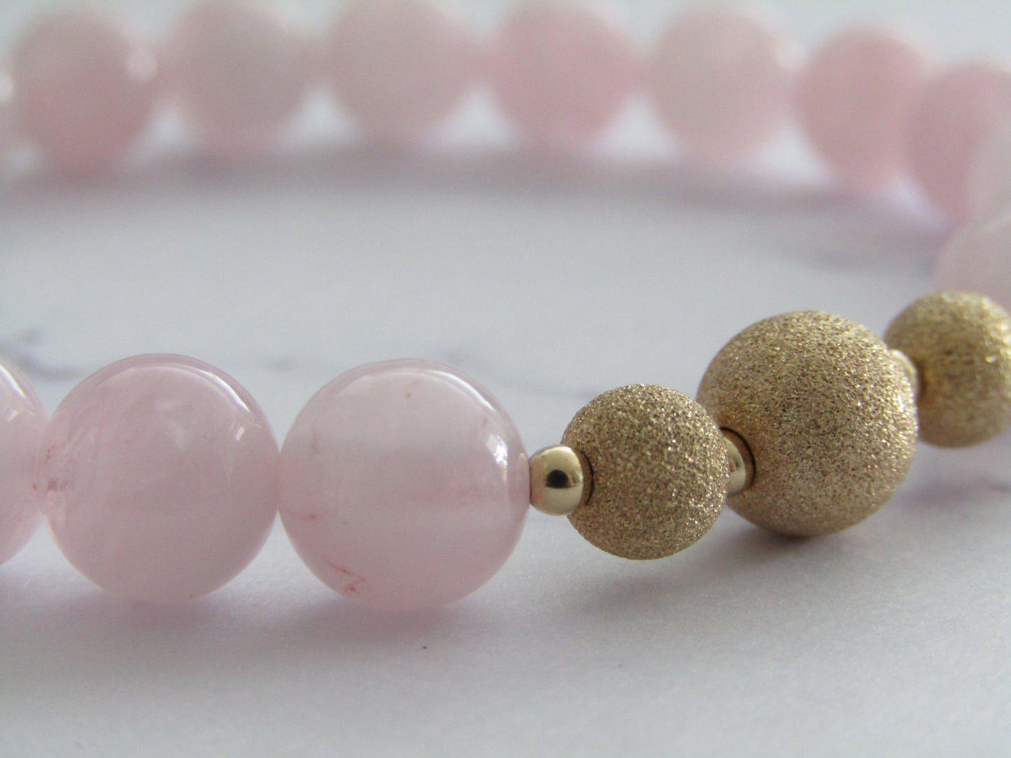 Grade A Madagascar Rose Quartz  bracelet with gold filled starburst beads - 8mm