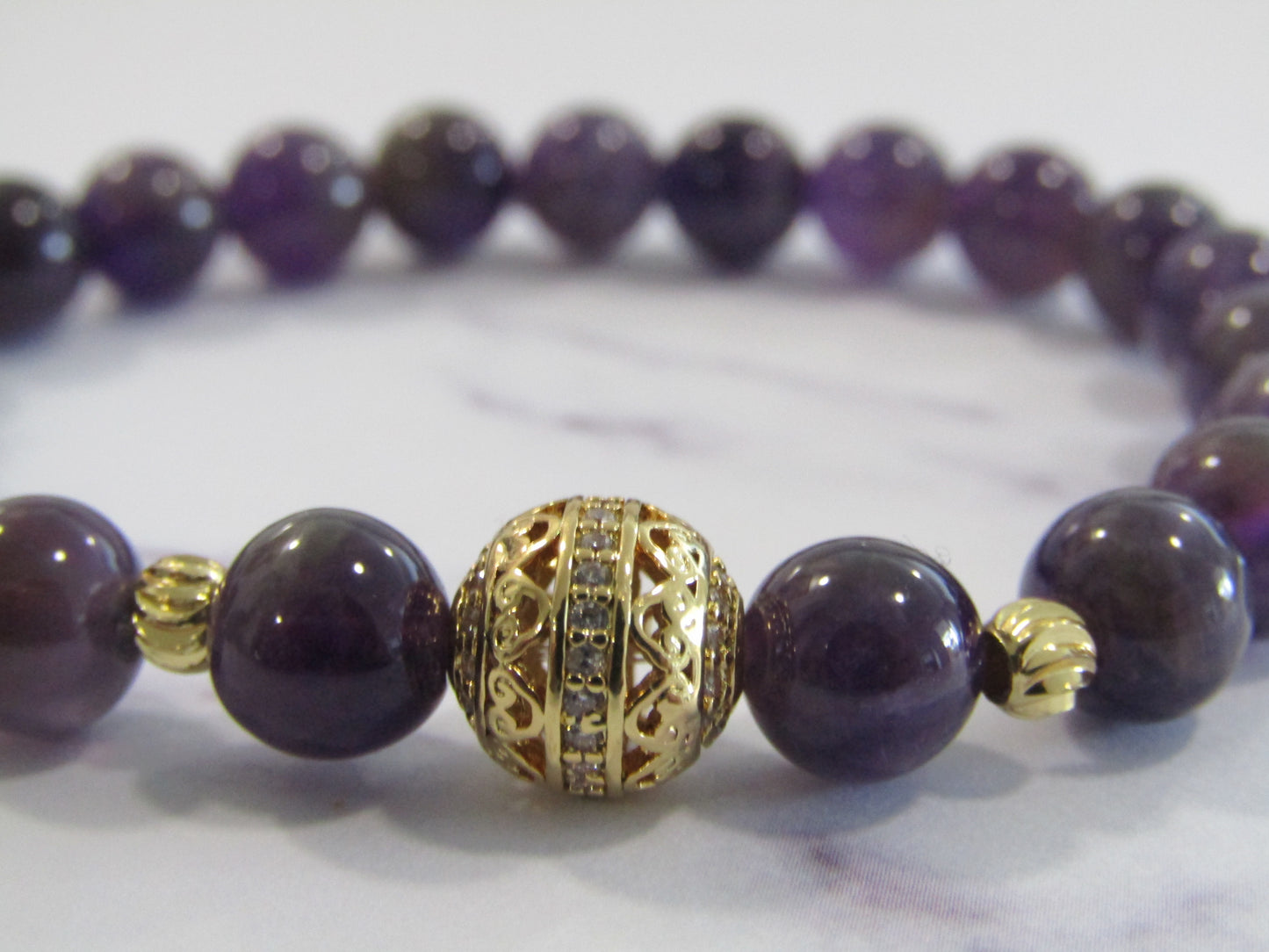 Grade A Amethyst bracelet with 18k gold plated cubic zirconia bead and 18k gold plated spacer beads - 8mm