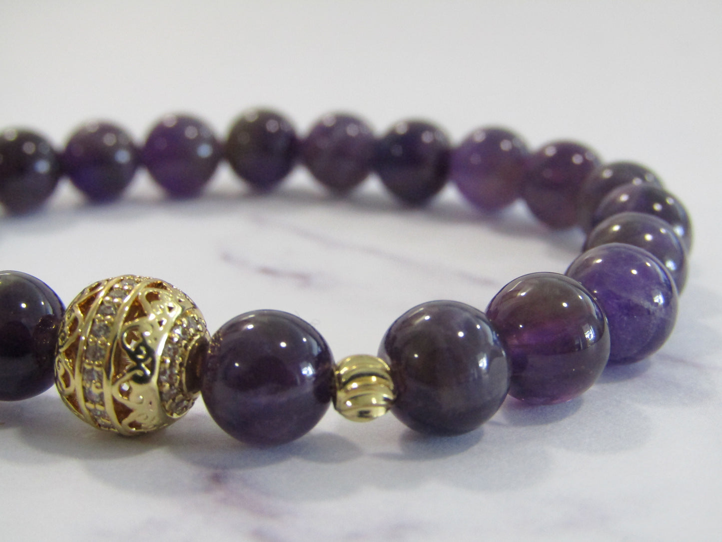 Grade A Amethyst bracelet with 18k gold plated cubic zirconia bead and 18k gold plated spacer beads - 8mm