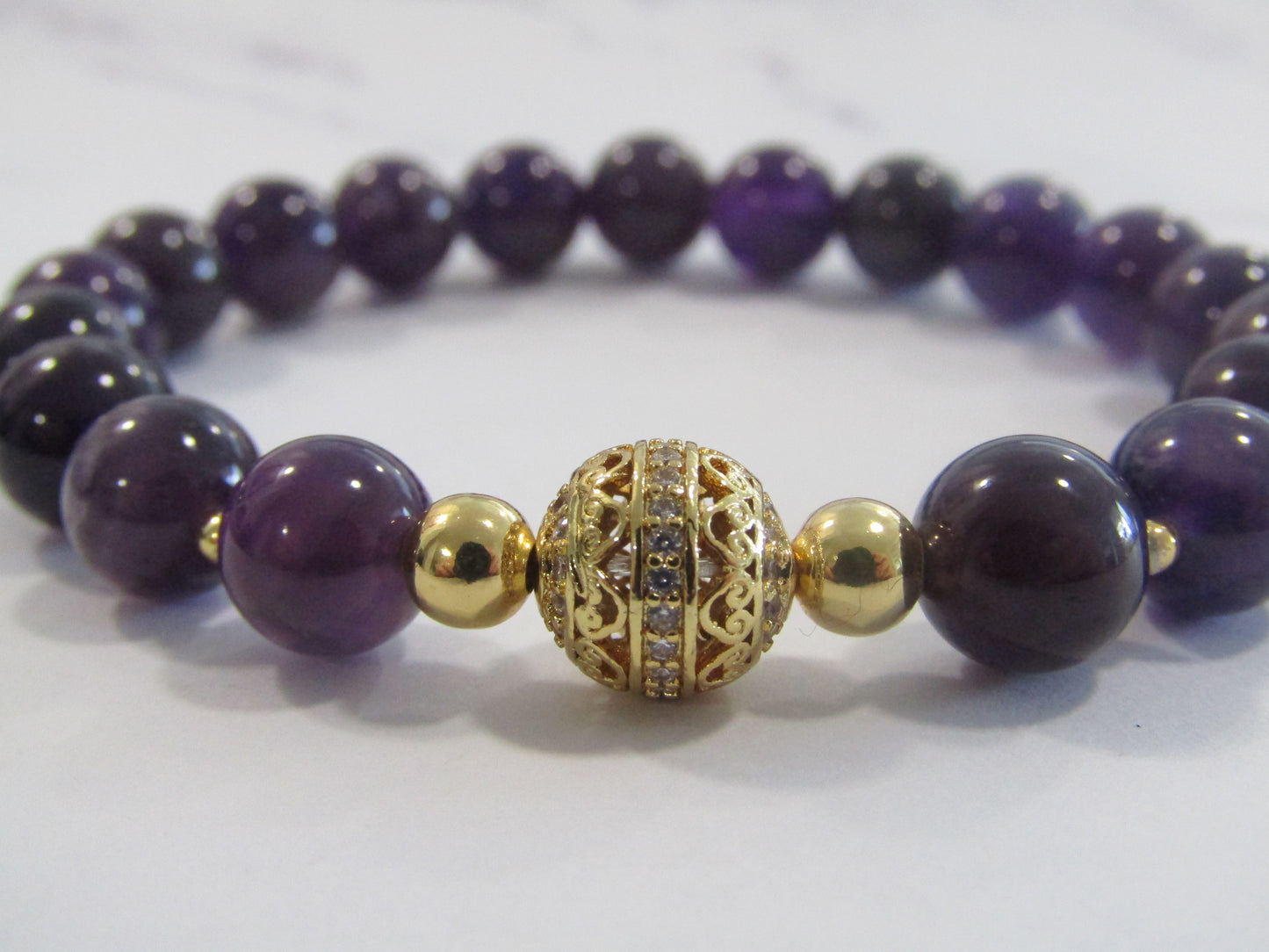 Grade AB Amethyst bracelet with 18k gold plated cubic zirconia bead and 18k (4 x) gold plated beads - 8mm