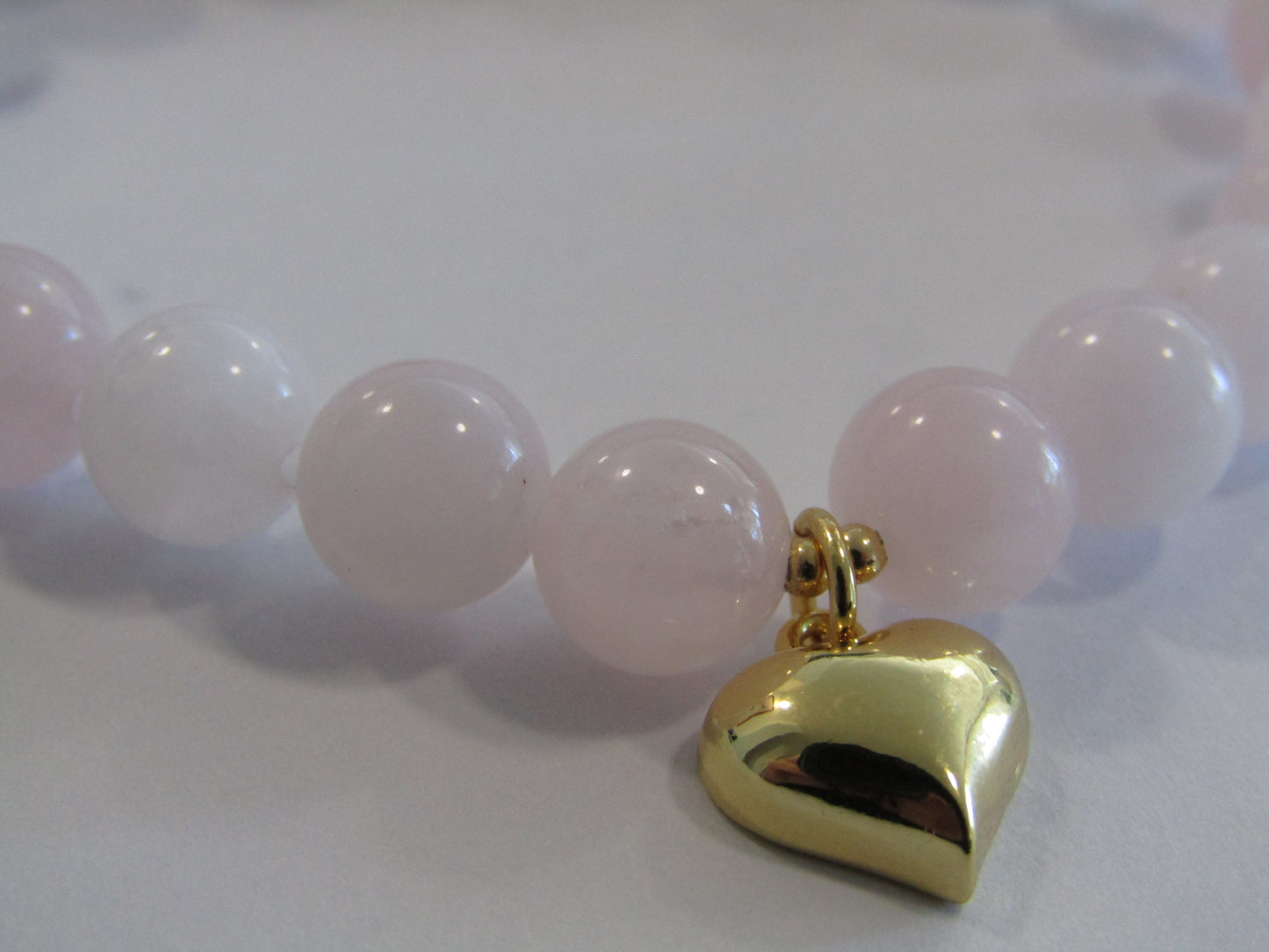 Grade A Madagascar Rose Quartz (8mm) bracelet with 18k gold plated heart charm and spacer beads