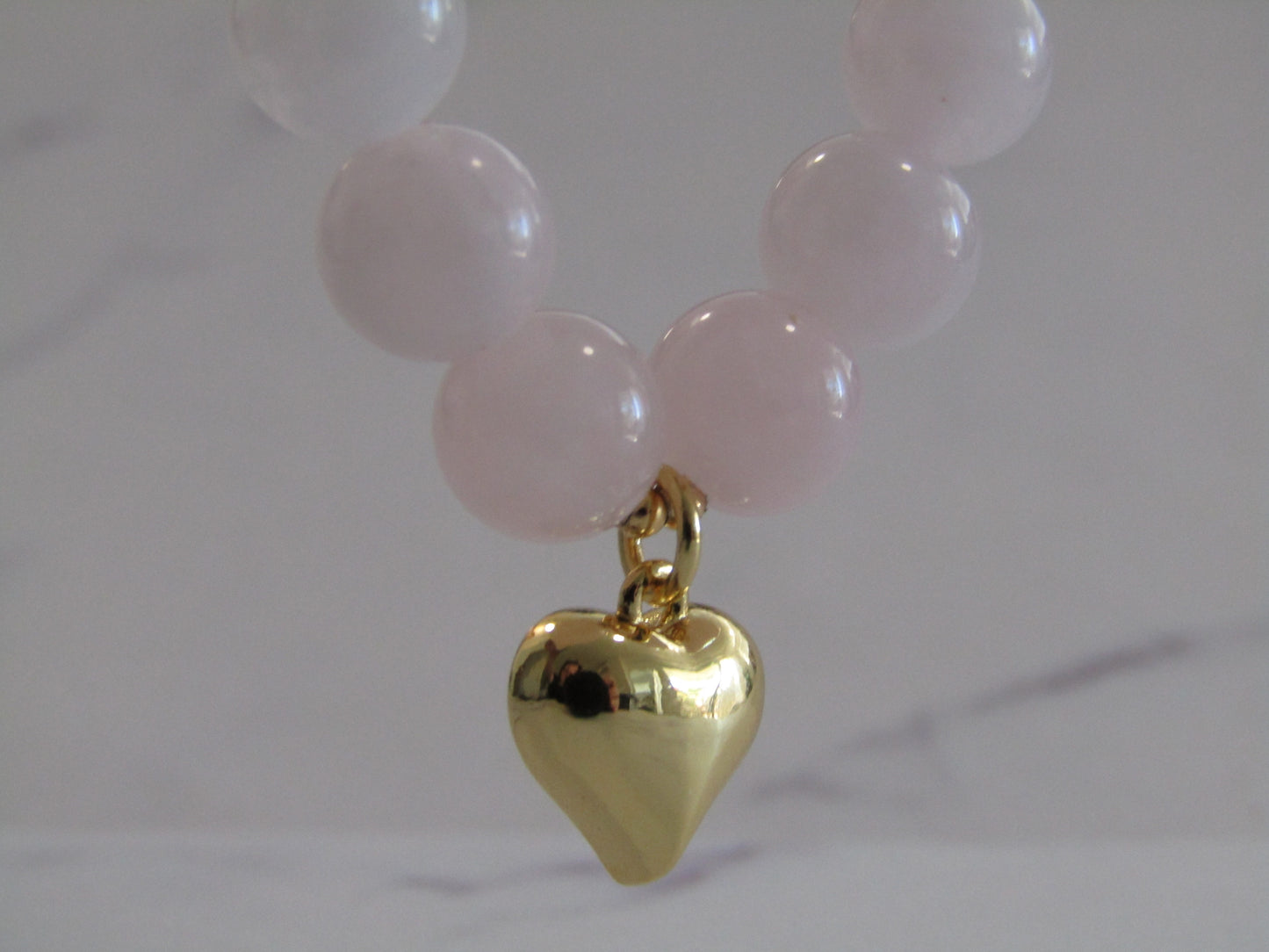 Grade A Madagascar Rose Quartz (8mm) bracelet with 18k gold plated heart charm and spacer beads