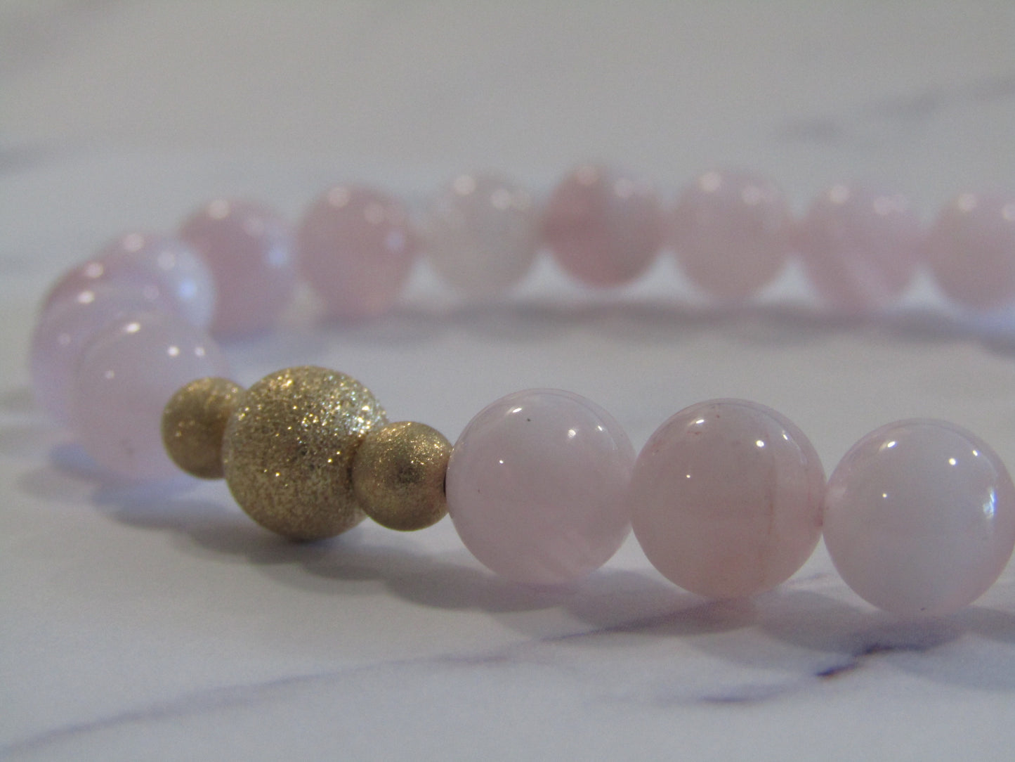 Grade A Madagascar Rose Quartz (8mm) bracelet with 14k gold filled starburst beads